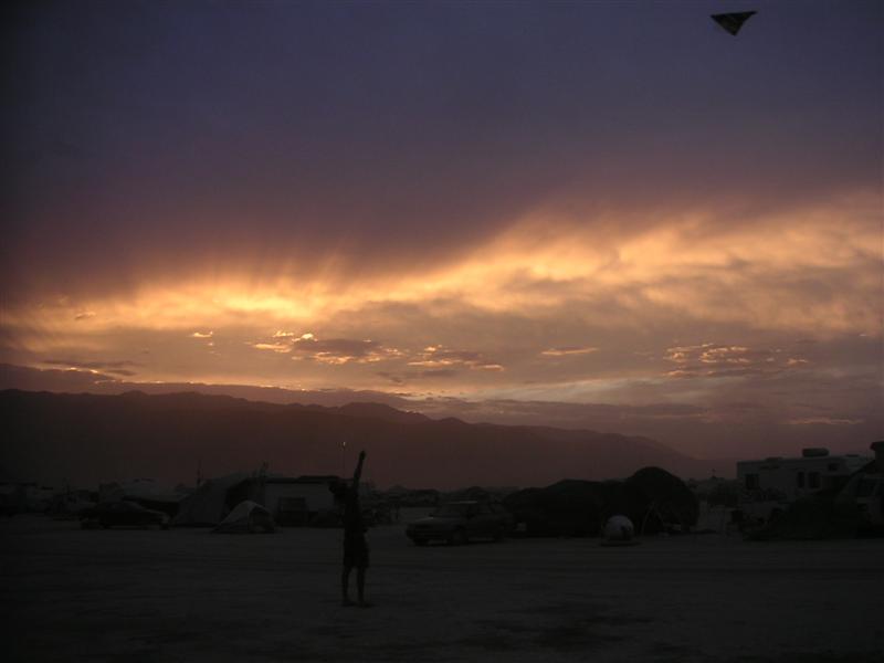 Crazy neighbor flying a kite at sunset