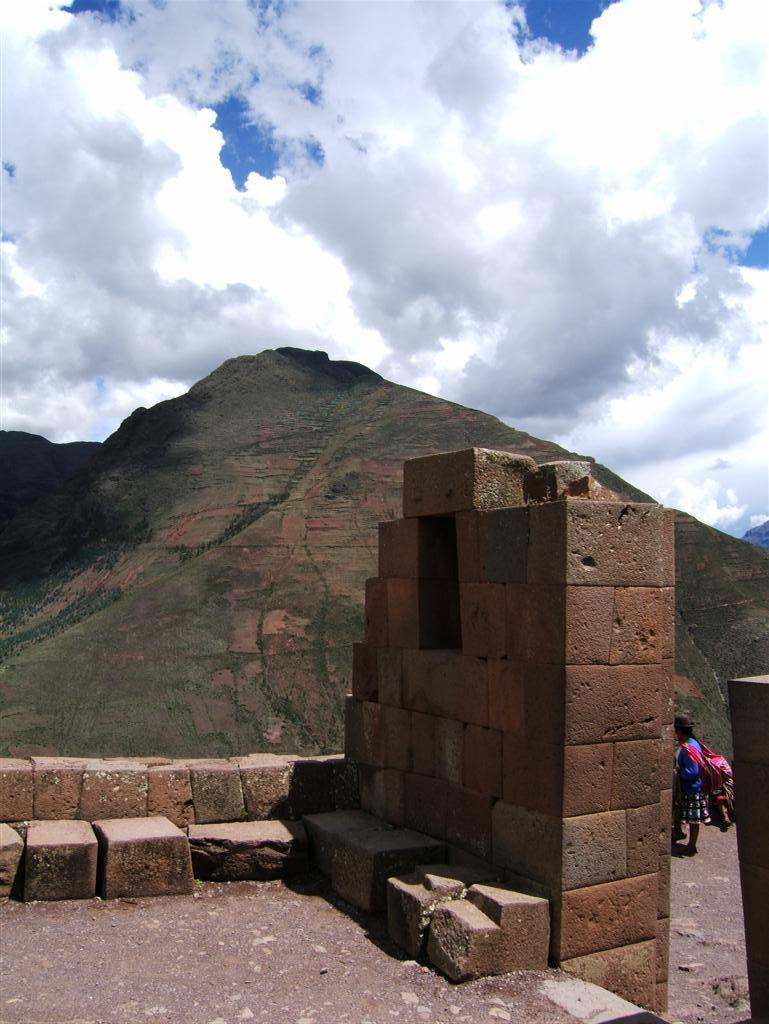 Square edged walls & a woman selling goods