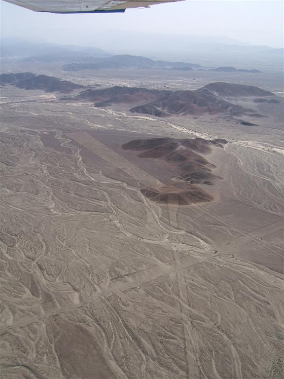 Flood lines flowing around the black hills of Nazca.