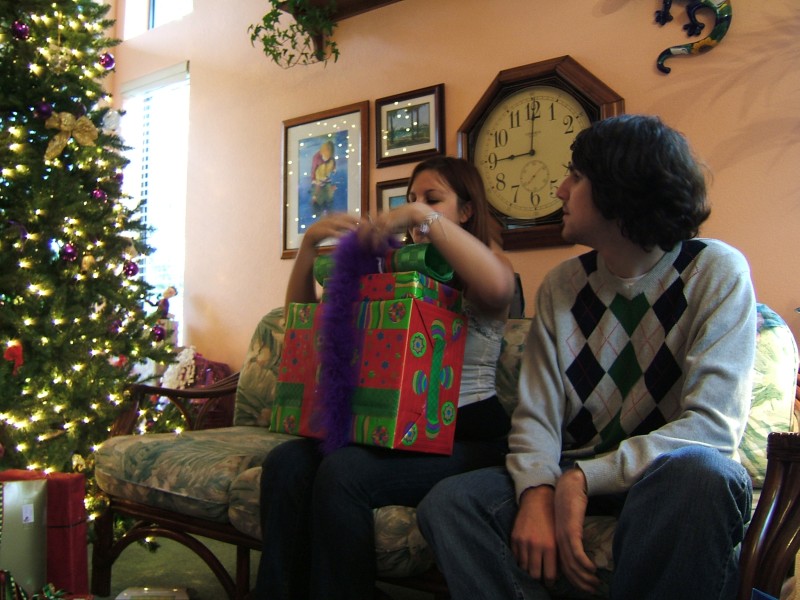 Drew looks on as Jenny digs into the presents