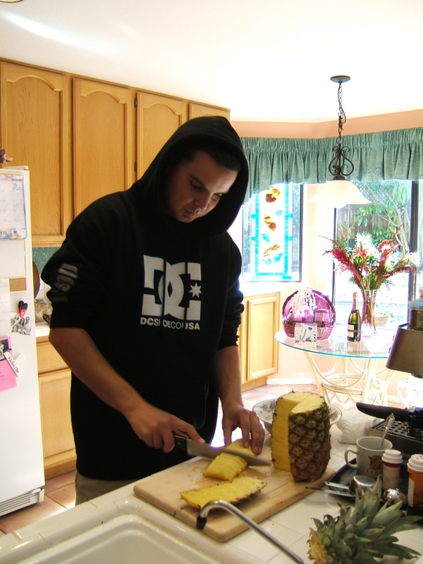 Gabe chopping up his Christmas pineapple