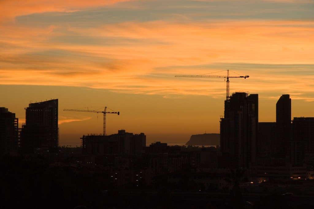 Sunset and cranes over downtown