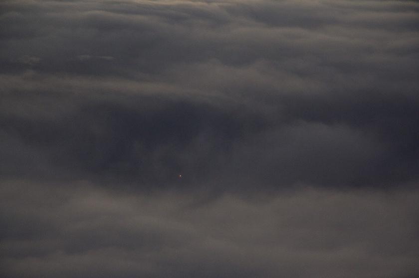 Single light through the sea of clouds