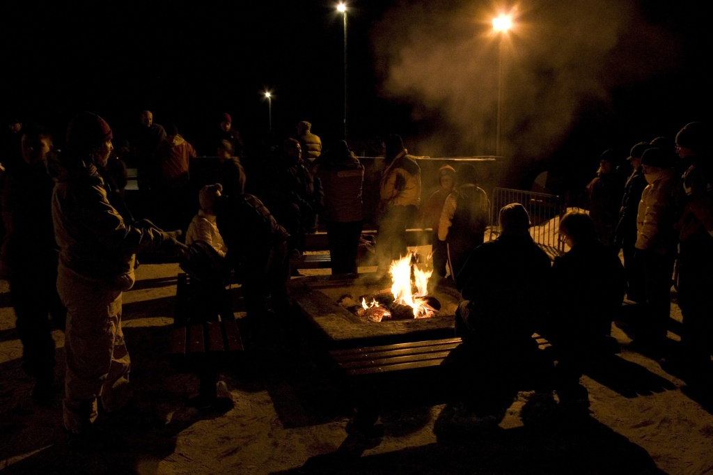 Crowding around the fire near the rink