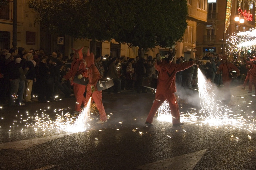 Red devils spraying sparks on the street