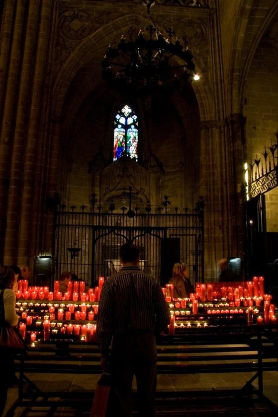 Lighting candles in the Cathedral of Santa Eulàlia