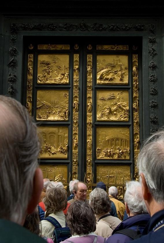 Tourists inspect Lorenzo Ghiberti's Gates of Paradise