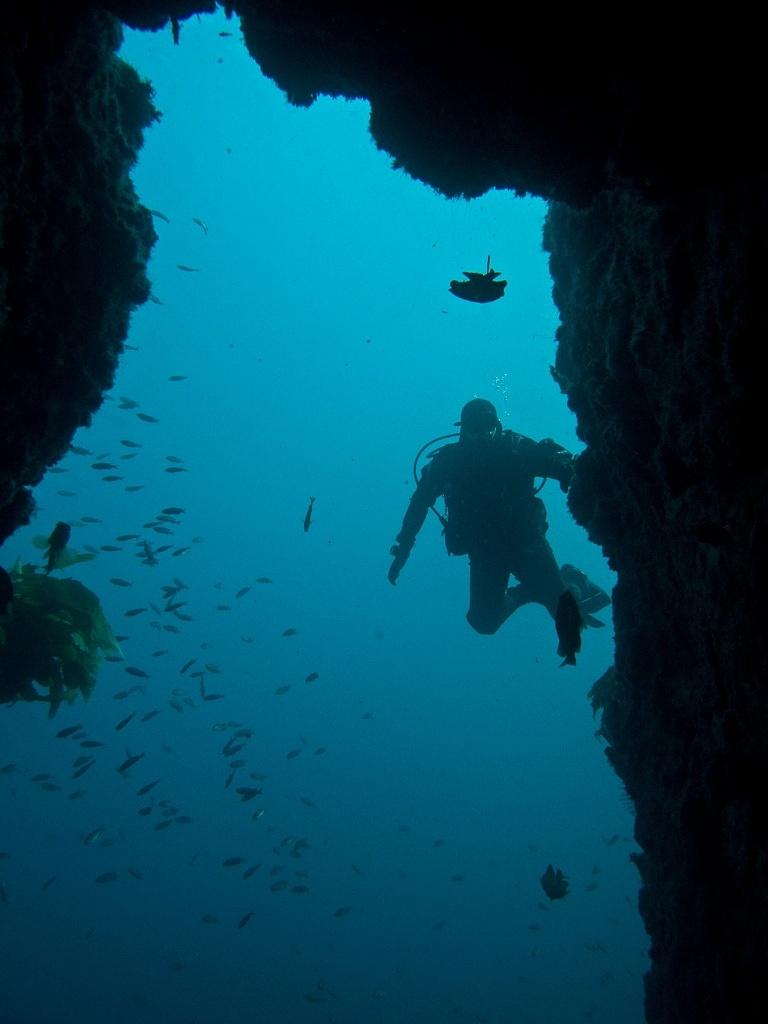 Adam looking in a cave on fishhook's wall