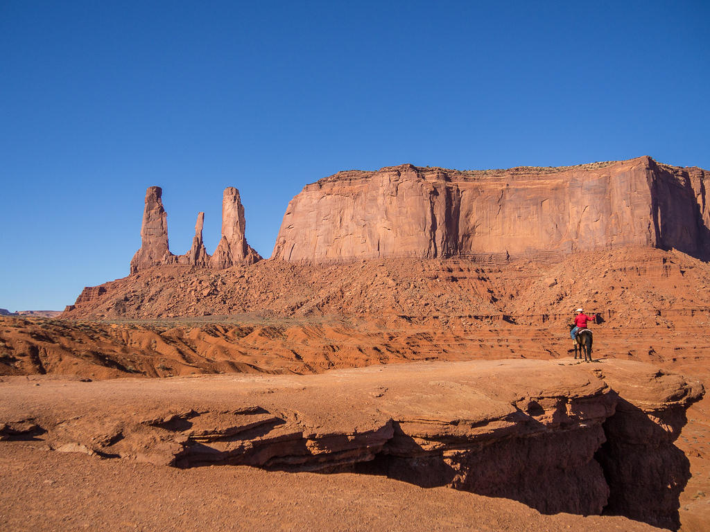 Cowboy photo op and Monument Valley's Three Sisters