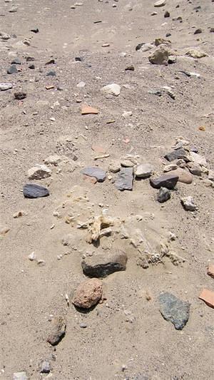 Shards of pottery and 2000 year old cotton drift in the wind.