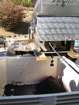 Out of the destemmer, into the grape mash bins