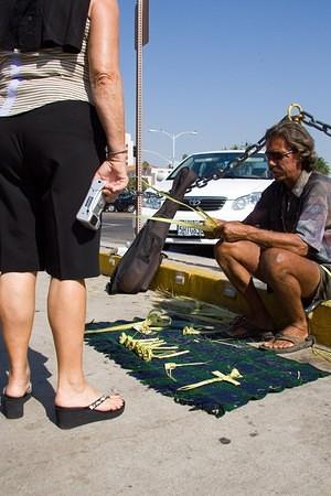 Making palm flowers for the cruise tourists