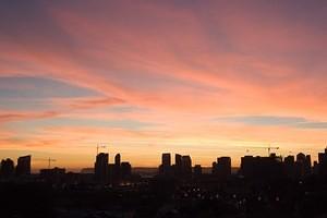 Sunset and cranes over downtown