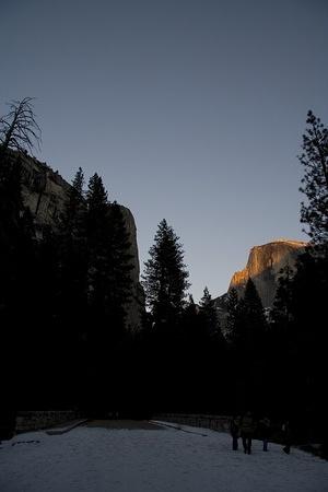 The top of Half Dome glows with the last light of the day