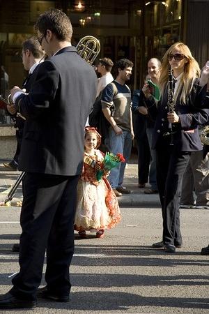 A little falleres watches the marching band