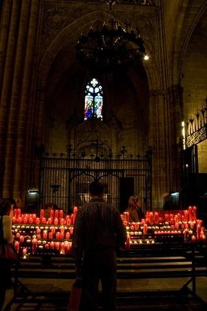 Lighting candles in the Cathedral of Santa Eulàlia