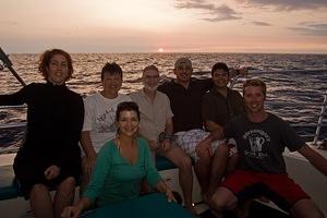 Family on the boat at sunset