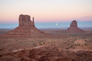 Monument Valley sunset and moonrise between the West and East mittens