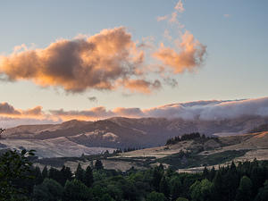 Setting sun over the rolling clouds